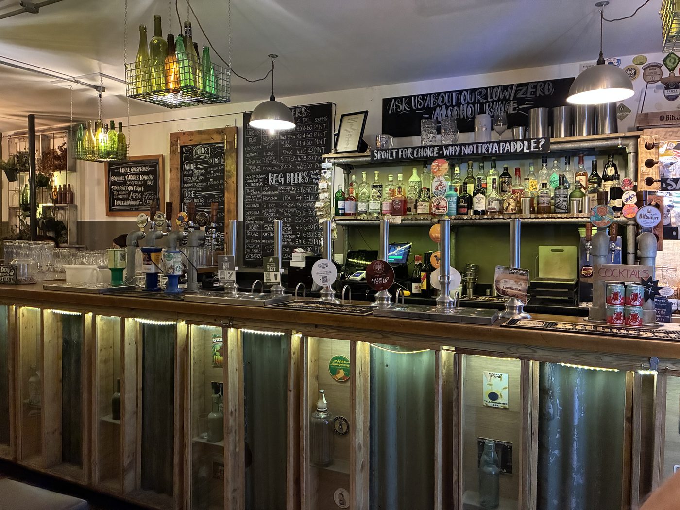 A traditional cask pub bar with a chalkboard reading “Ask us about our low/zero alcohol range”